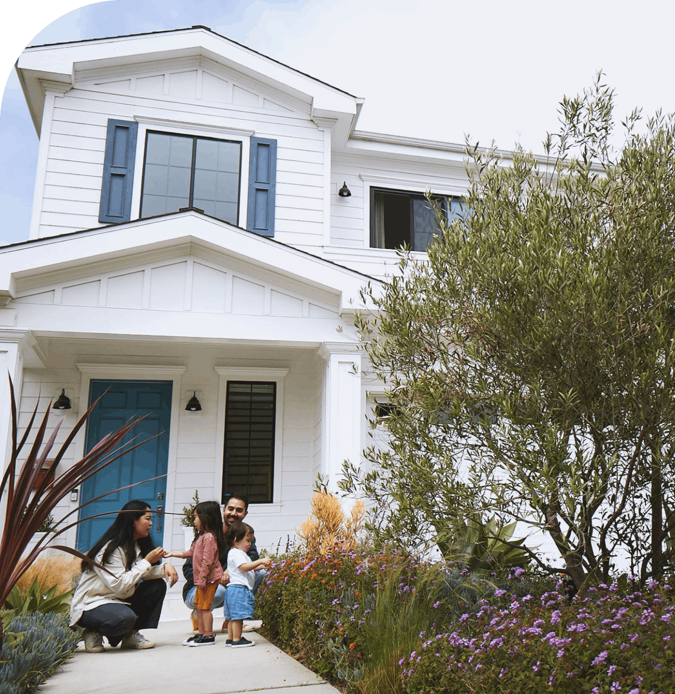 A family in their front yard with the Opendoor app showing the home details and how to buy it.
